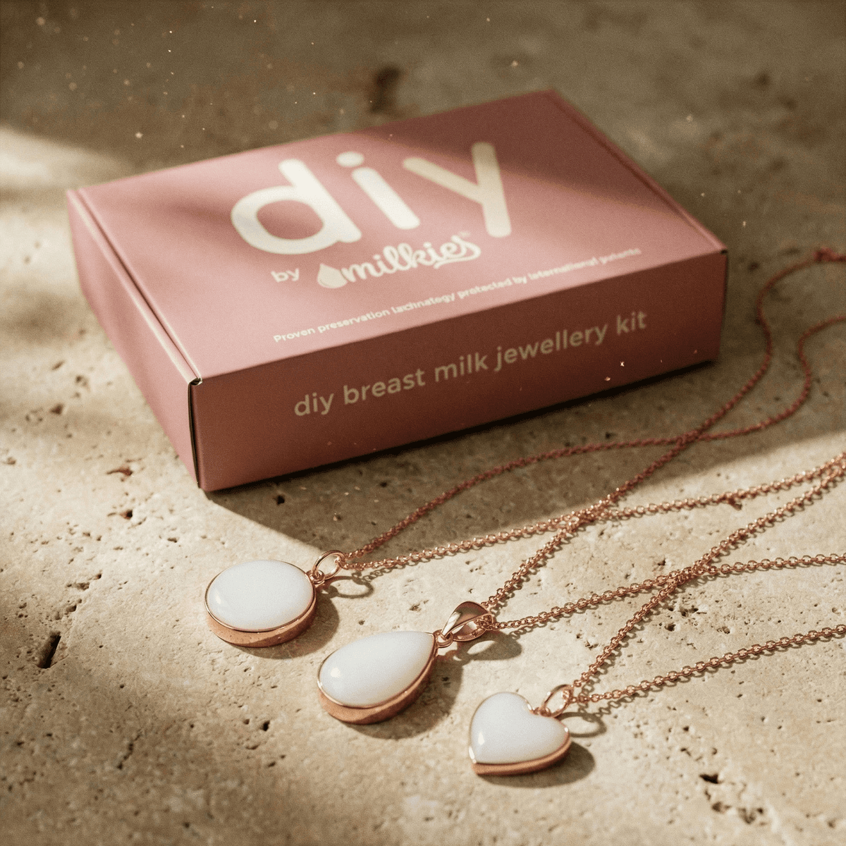 Kit de DIY by MILKIES para preservar leche materna y crear joyas, con un kit para hacer colgantes lactancia en resina y collares dorados con dijes blancos en forma de círculo, gota y corazón.